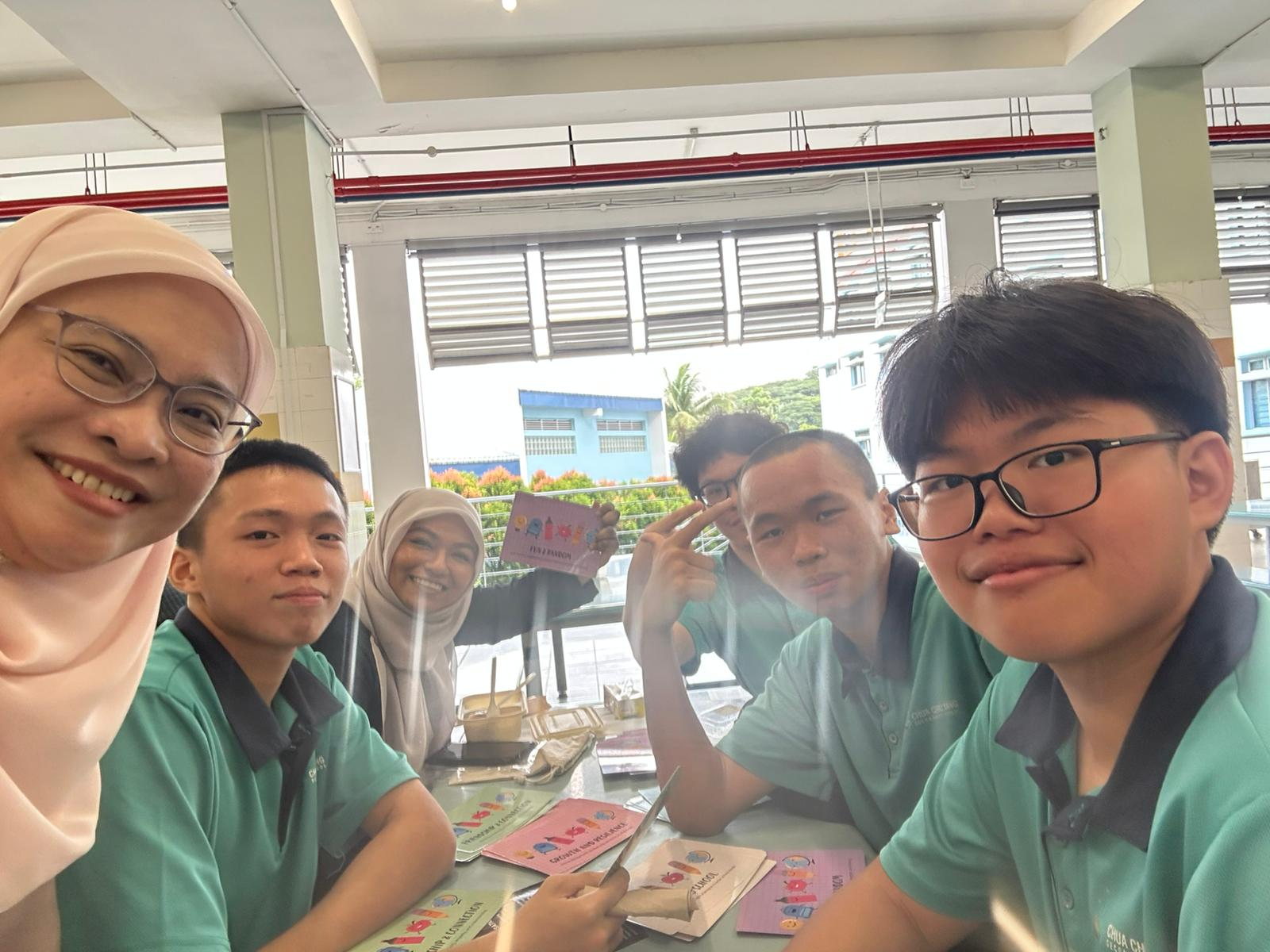Vice principal having breakfast with students in the canteen